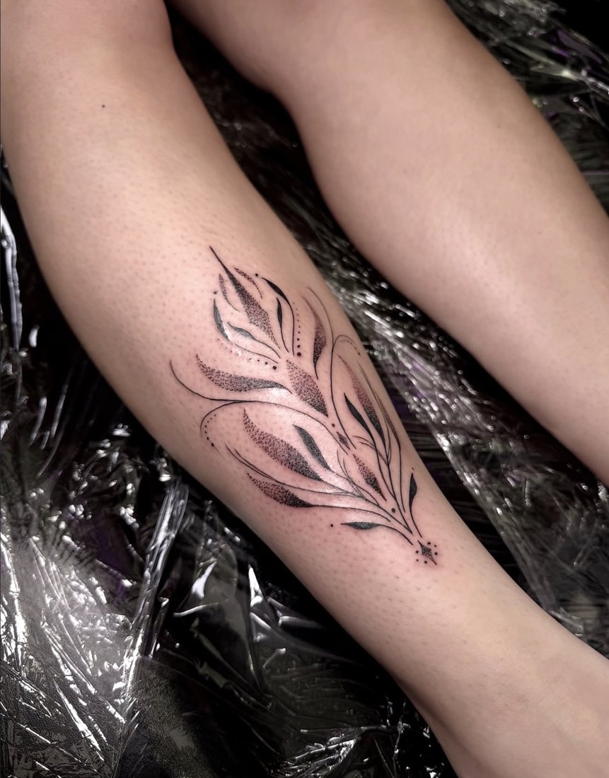 Abstract dotwork floral tattoo on the calf