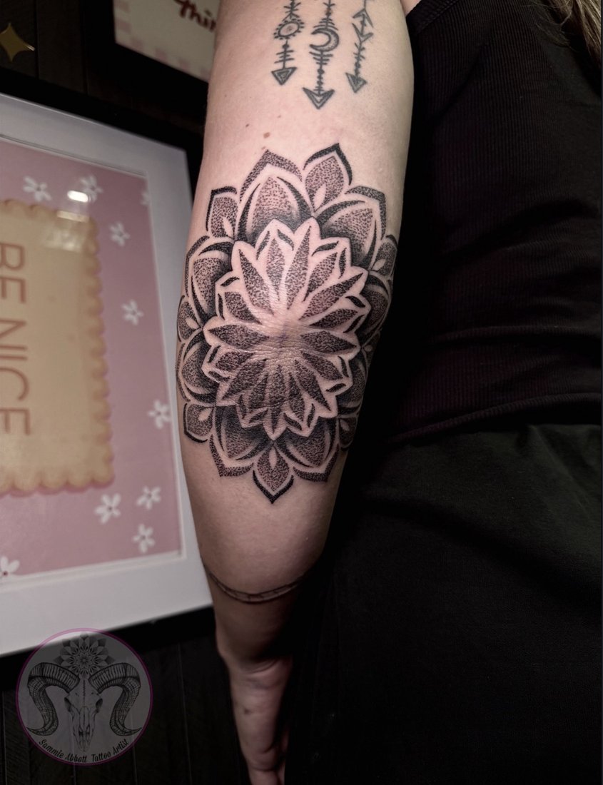 Dotwork mandala tattoo centred on the elbow