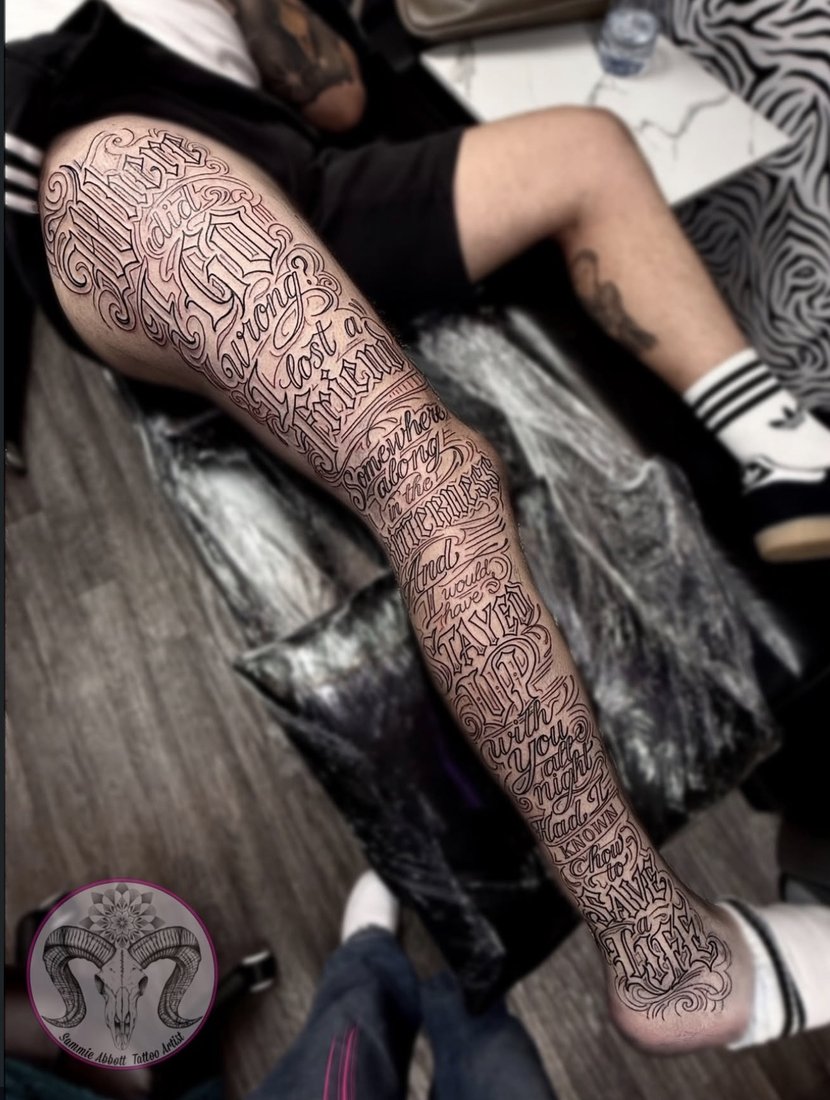 Full-leg script and lettering tattoo reading words of remembrance