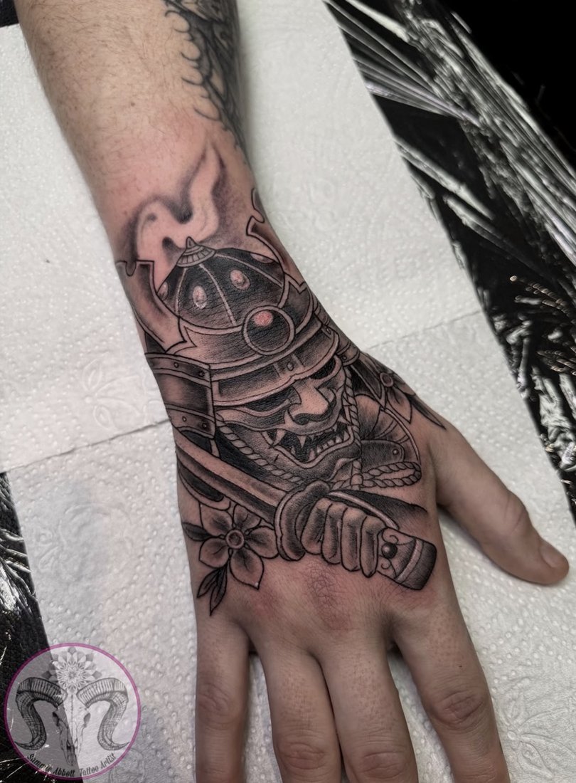 Samurai mask and katana hand tattoo with cherry blossom