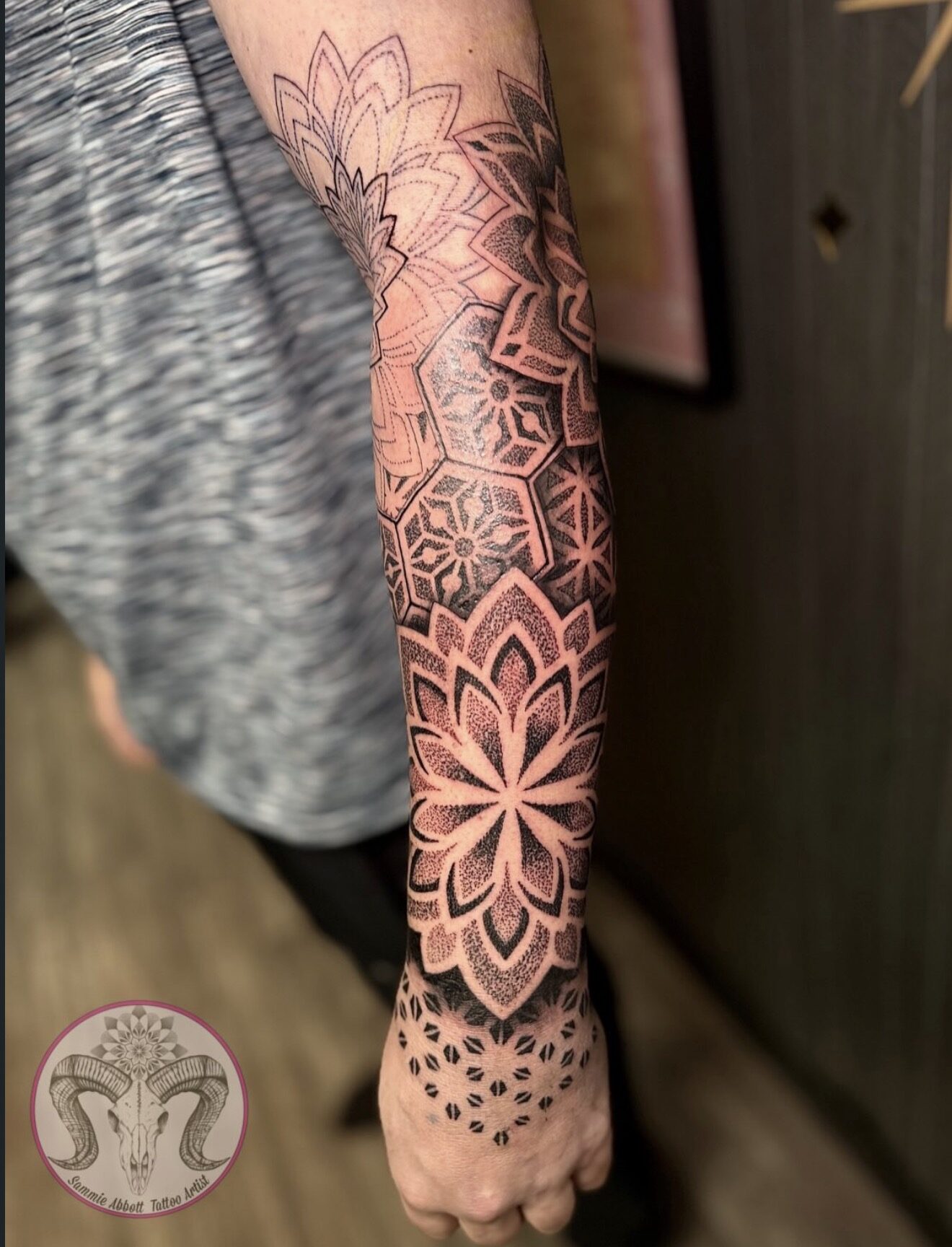 Geometric floral sleeve with hexagons flowing onto the hand