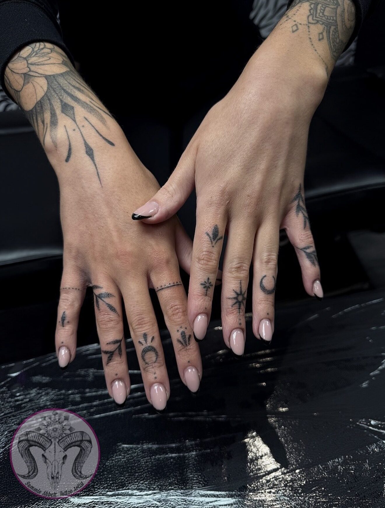 Crescent moons, stars and leaves across the fingers
