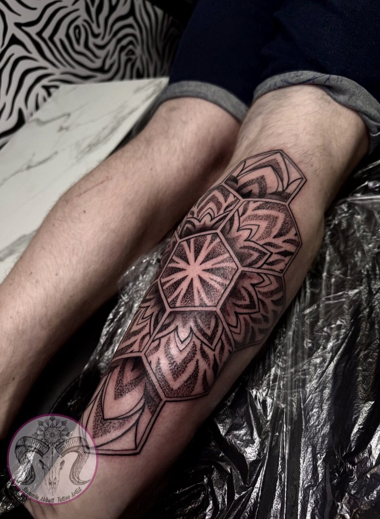 Mandala set inside hexagonal frames on the calf