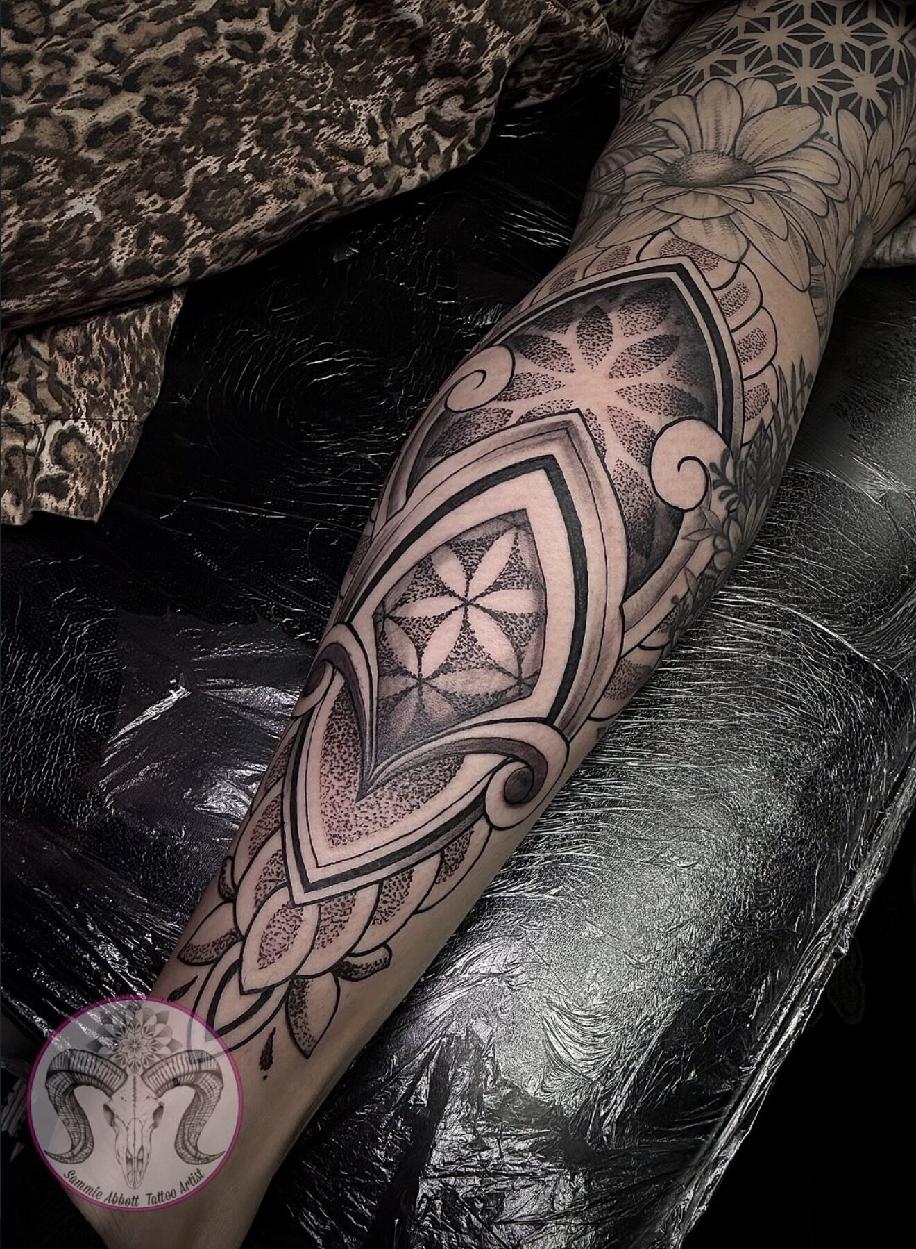 Dotwork mandala and sacred geometry on the calf