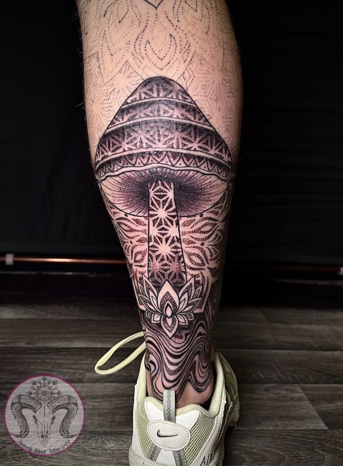 Geometric dotwork mushroom tattoo on calf