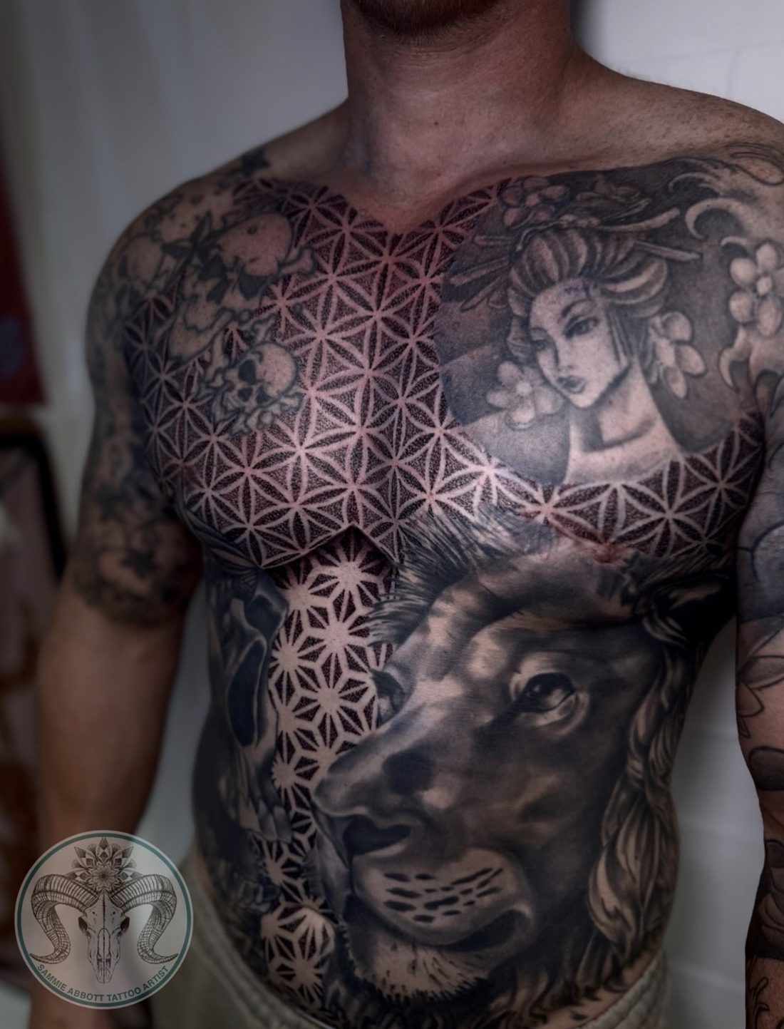Geometric chest piece with geisha and lion