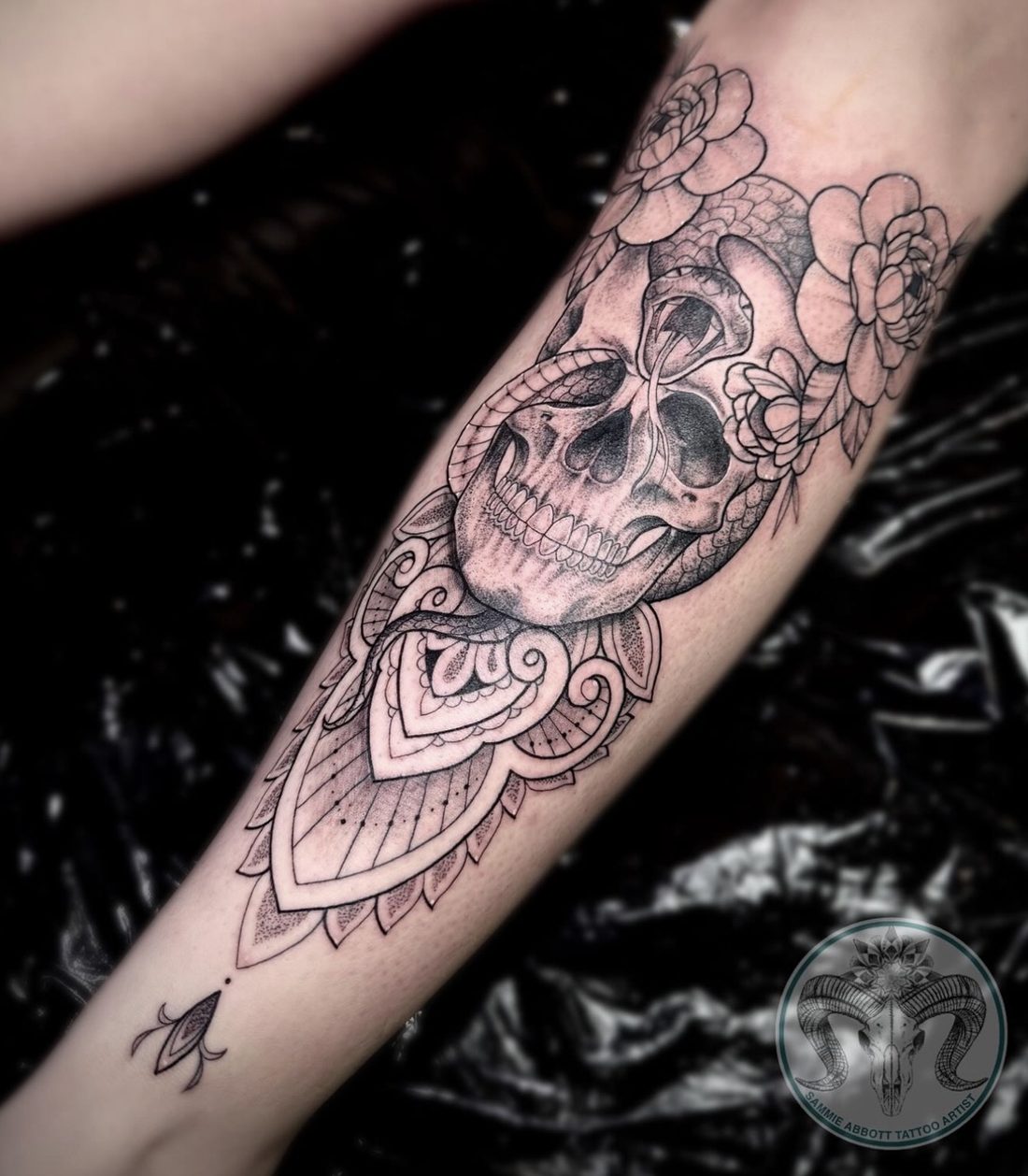 Skull with peonies and mandala detail on forearm